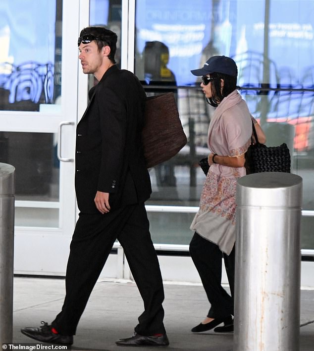 Harry Styles cut a smart figure as he and fiancée Zoe Kravitz touched down at JFK Airport in New York City on Friday ahead of his 30-date residency at Madison Square Garden