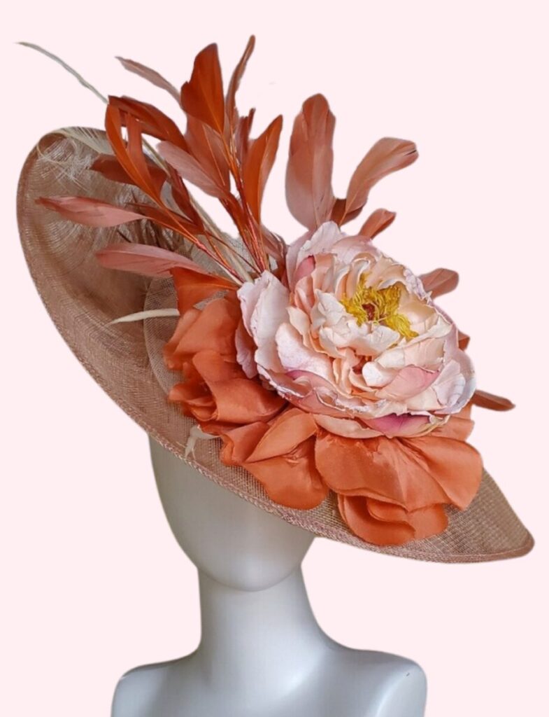What Makes a Great Kentucky Derby Hat? – Garden & Gun A beige hat with coral and light pink accents