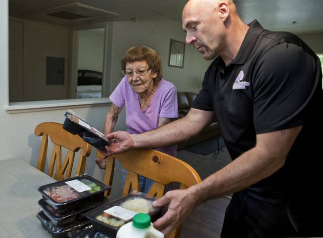 Meals on Wheels volunteer Michael Prior delivers food to client Carmen Roybal, 87 years old, Friday, June 10, 2016.