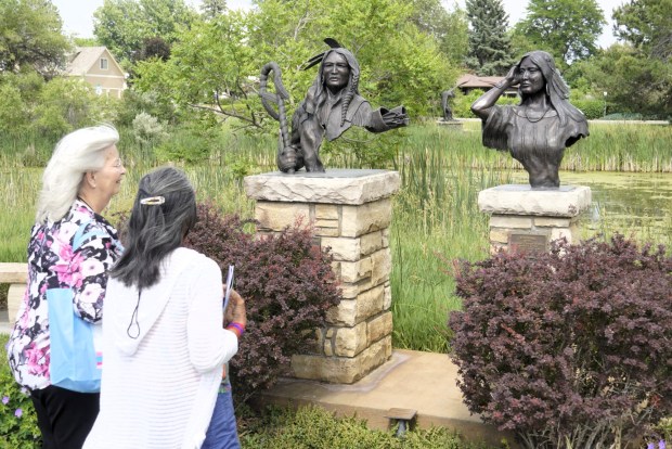 City officials attending the Colorado Municipal League conference admire High Plains Warrior and Windsong by George Walbye, one of the first pieces placed in Loveland's Benson Sculpture Park. Around 60 conference-goers stopped took a guided tour of the park on Wednesday afternoon.(Riley Laub/Loveland Reporter-Herald)