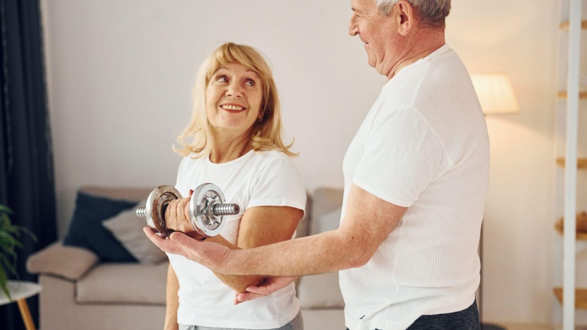 This is a photo of a senior man helping his wife lift weights. See PA Feature HEALTH Physio. WARNING: This picture must only be used to accompany PA feature HEALTH Physio. PA Photo.Picture credit should read: Alamy/PA. NOTE TO EDITORS: This picture must only be used to accompany PA Feature HEALTH Physio.