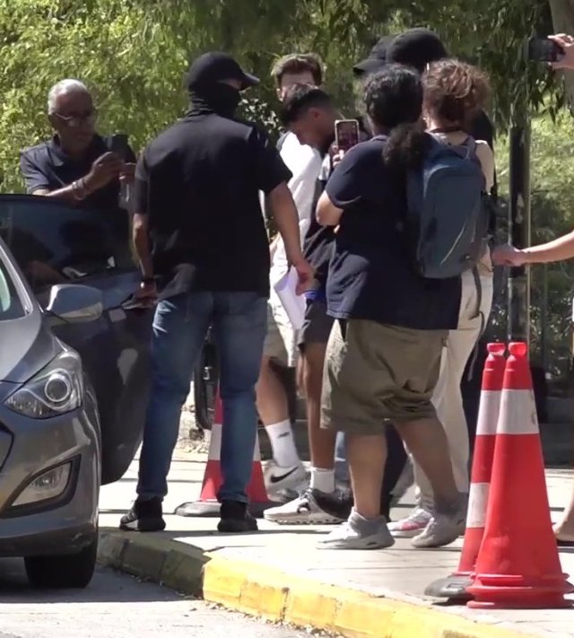 BEST QUALITY AVAILABLE Screen grab taken from PA Video of Sharif Ahmadzai (centre) is led out of the Athens Court House complex in Kypseli, Athens, where he appeared accused of killing 38-year-old Elisabeth-Jane Ross and disposing of her body in a suitcase. Ms Ross was discovered dead by a homeless man in a derelict building in the Kypseli area of the Greek capital on July 18. Picture date: Wednesday August 5, 2026. PA Photo. Photo credit should read: Nick Forbes/PA Wire