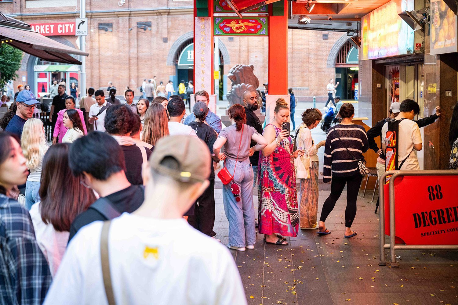 People pictured in a queue outside Emperor's Garden & Bakery (AKA the cream puff place) in Sydney's Chinatown