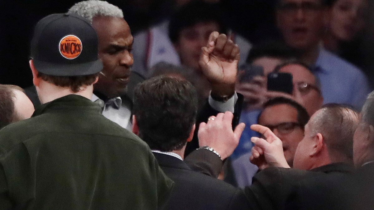Former New York Knicks player Charles Oakley exchanges words with a security guard during the first half of an NBA basketball game between the New York Knicks and the LA Clippers Wednesday, Feb. 8, 2017, in New York. (AP Photo/Frank Franklin II)