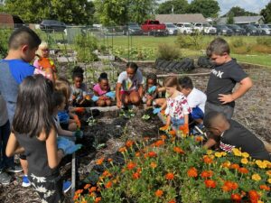 Sam Houston Elementary teacher Shay Wynne and her students learn about plants in the HEAT garden classes.SUBMITTED