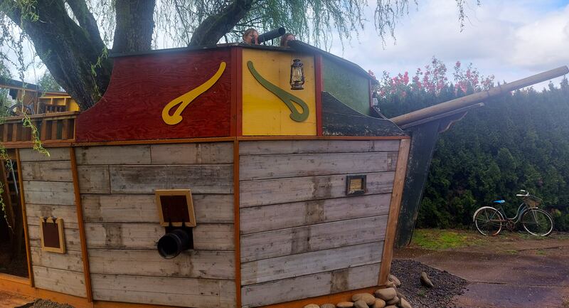 Children on a pirate ship play structure