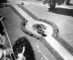 An aerial view of Sister Marguerite D'Amours gardening at Providence Academy's front yard in Vancouver, Wash., in 1961.