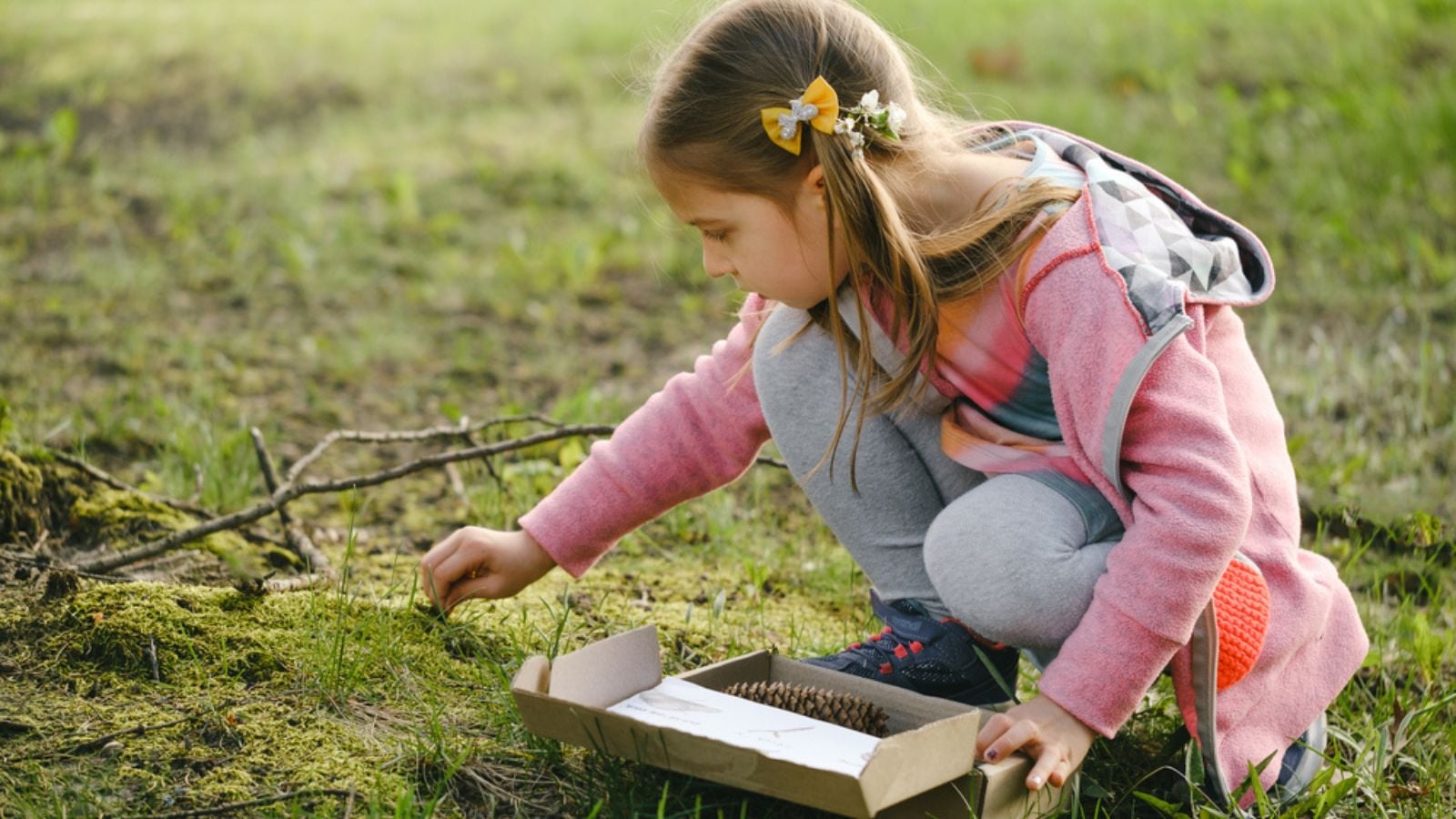 Scavenger hunt for kid in the park. Girl learning about environment. Natural education activity for World Earth day.