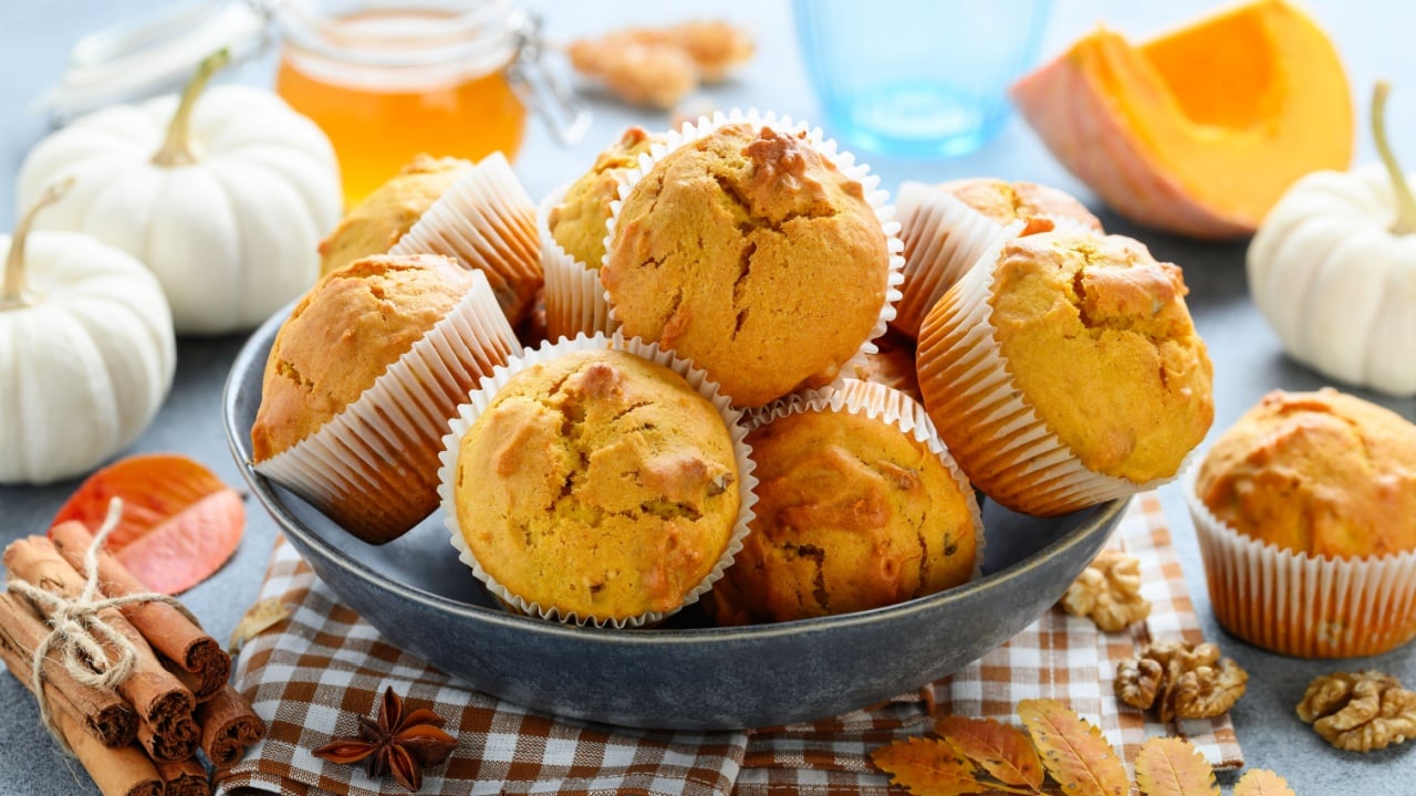 Pumpkin muffins with spices and walnuts in a plate. Autumn healthy dessert. Selective focus 