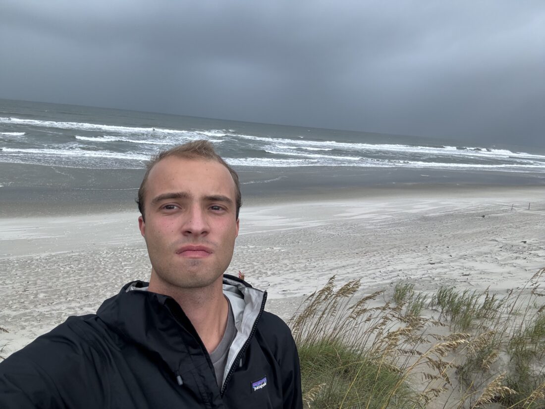 A man takes a selfie at the beach