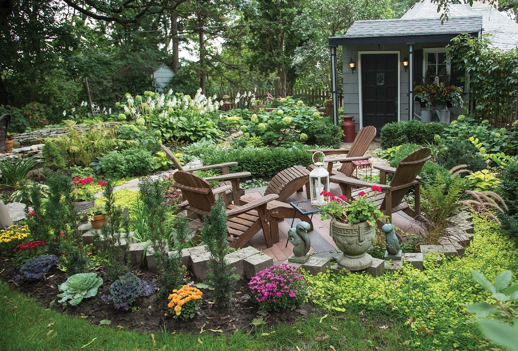 Lounge chairs nestled within the leafy greenery of the garden create an ideal space for relaxation. 